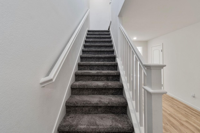 stairs with wood-type flooring