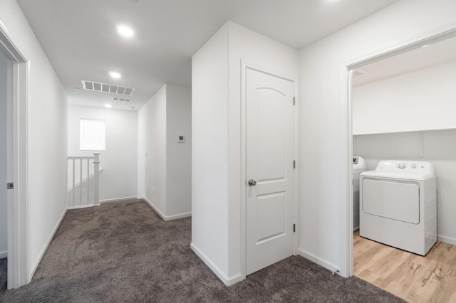 hallway featuring carpet and separate washer and dryer