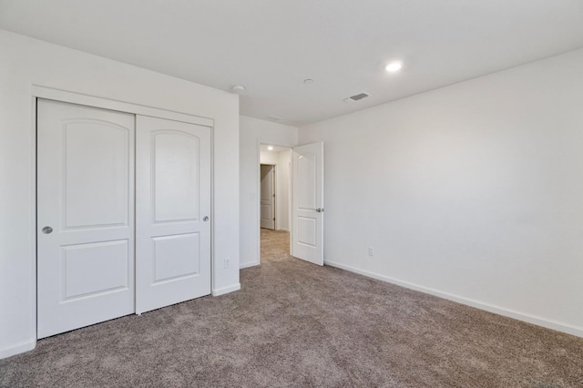 unfurnished bedroom featuring a closet and carpet