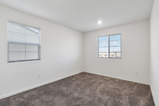 empty room featuring dark carpet