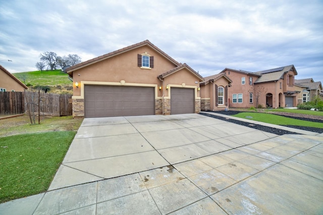 view of front of property with a garage and a front yard