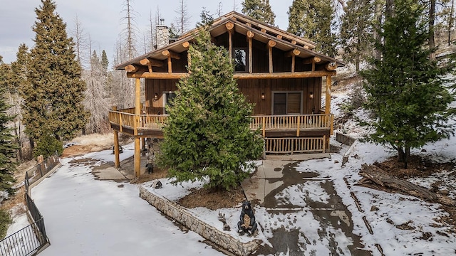 log-style house featuring a wooden deck