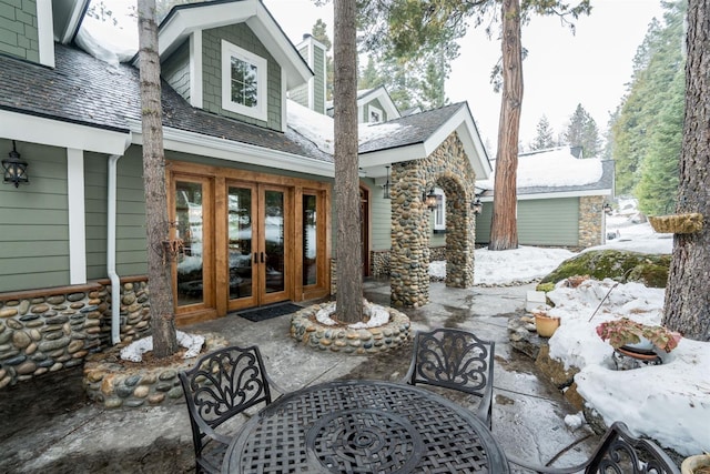 snow covered patio with french doors