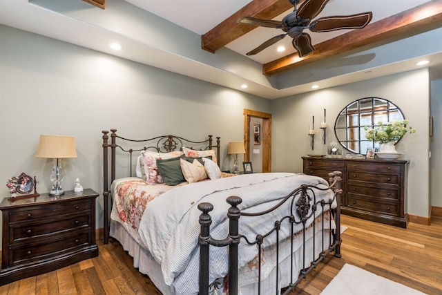 bedroom featuring beamed ceiling, ceiling fan, and wood-type flooring