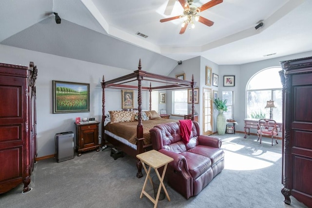 bedroom featuring light colored carpet, ceiling fan, and a tray ceiling