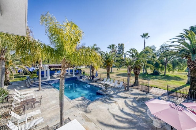 view of pool featuring a patio and a lawn