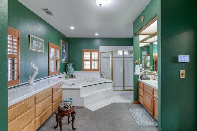 bathroom with vanity and separate shower and tub