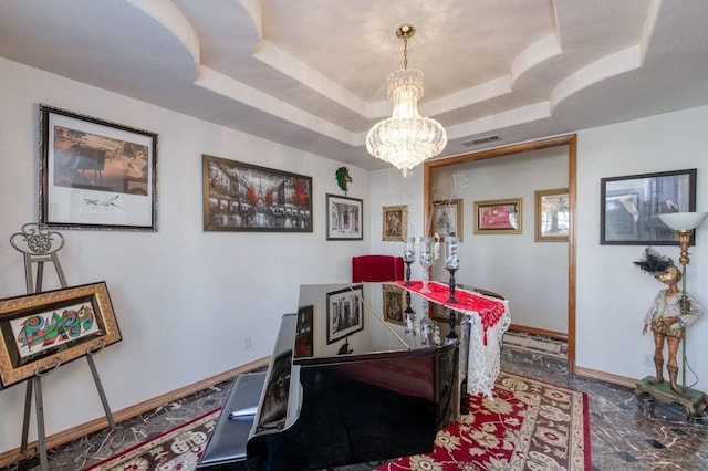 dining room with a tray ceiling and a chandelier