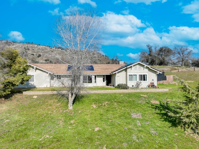 back of property featuring a lawn