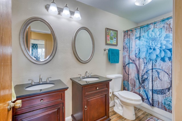 full bathroom with vanity, toilet, wood-type flooring, and shower / bath combo