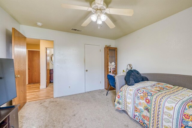 bedroom with ceiling fan and light carpet