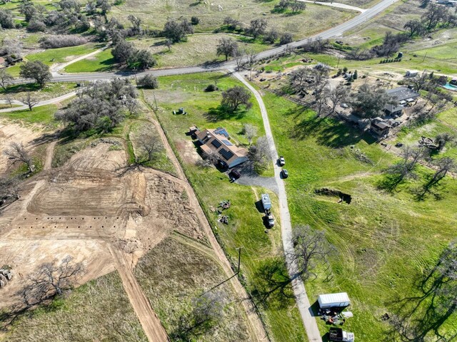 birds eye view of property with a rural view