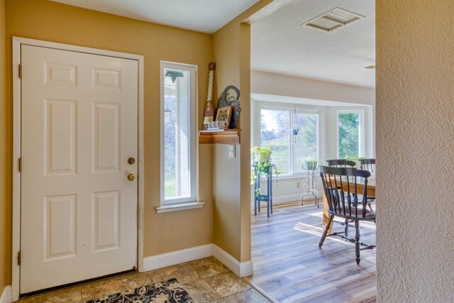 foyer entrance with plenty of natural light and light hardwood / wood-style floors