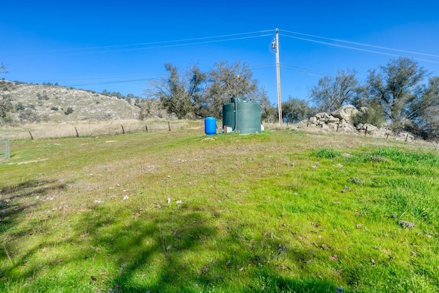 view of yard with a rural view