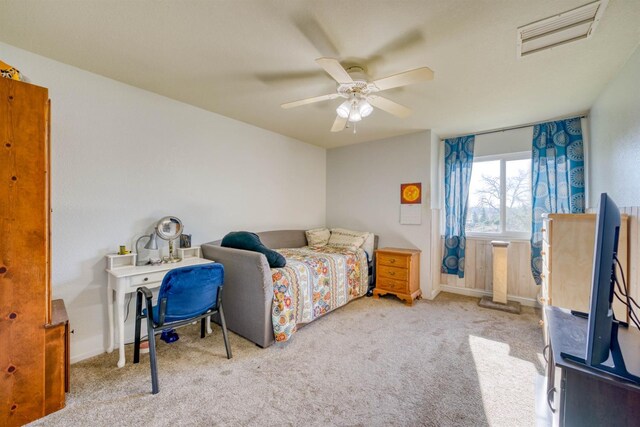 bedroom featuring light carpet and ceiling fan