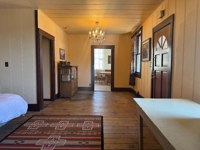 interior space featuring wooden ceiling, dark wood-type flooring, and a notable chandelier