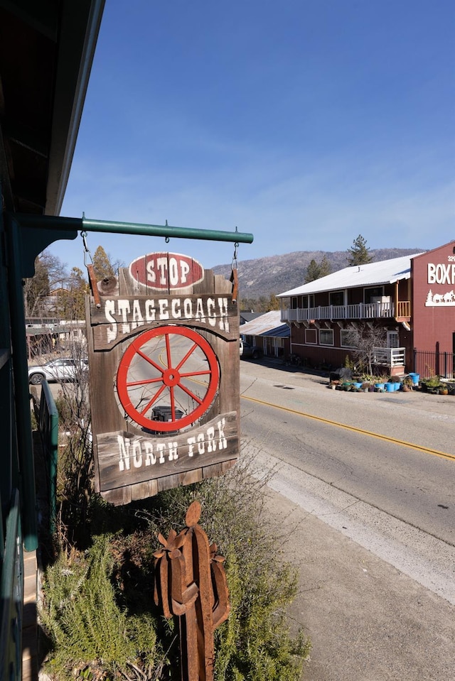 community / neighborhood sign with a mountain view