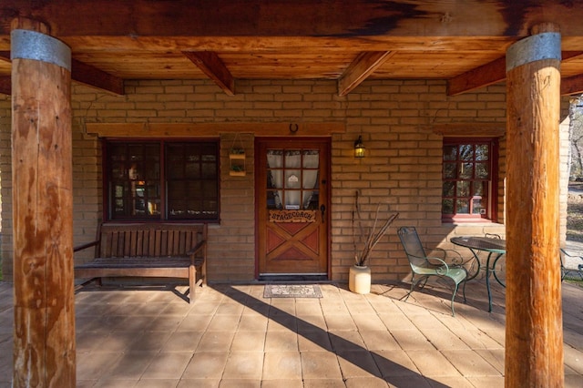 view of exterior entry with a porch