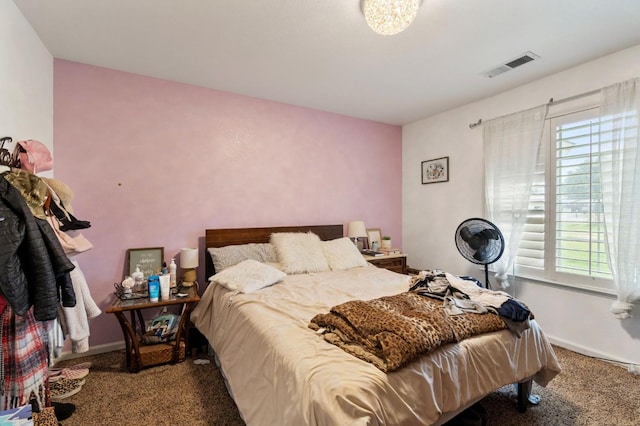 bedroom featuring visible vents, multiple windows, and carpet flooring