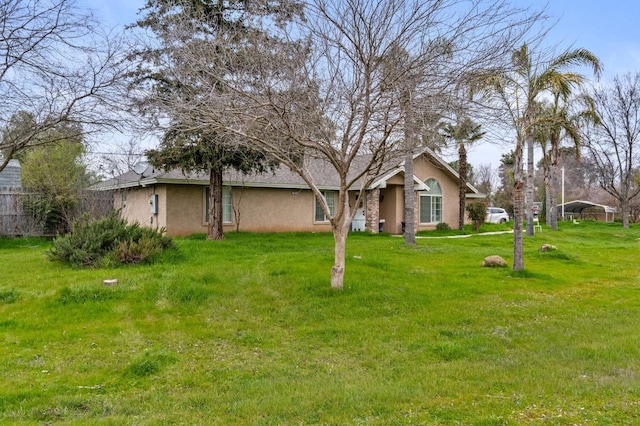 view of yard with fence and a carport