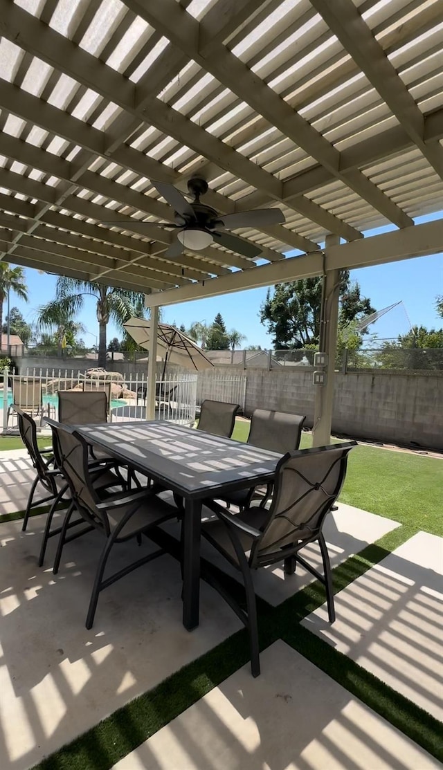 view of patio / terrace with ceiling fan and a pergola