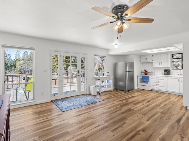 doorway to outside with sink, a wealth of natural light, and light hardwood / wood-style flooring