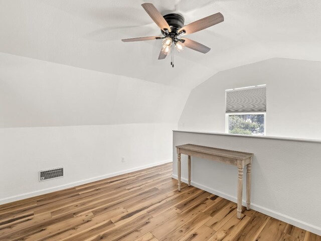 bonus room with hardwood / wood-style flooring, lofted ceiling, and ceiling fan