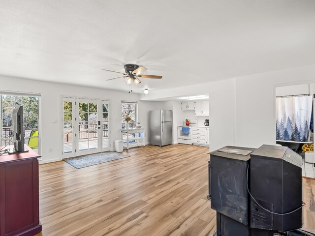 living room with ceiling fan and light hardwood / wood-style flooring