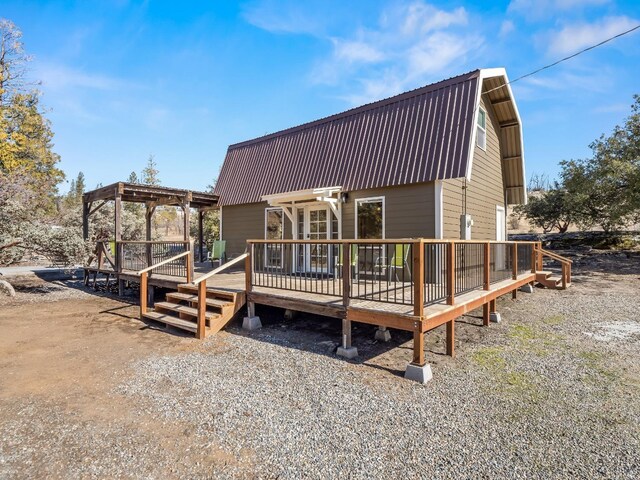 back of house with a wooden deck