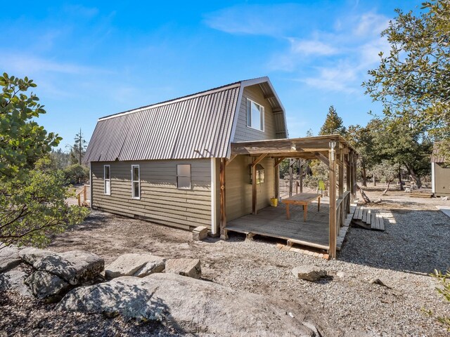 view of home's exterior featuring a wooden deck