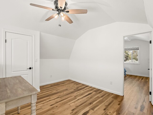 additional living space featuring vaulted ceiling, ceiling fan, and light wood-type flooring