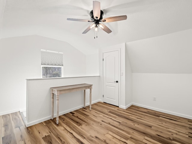 bonus room with ceiling fan, vaulted ceiling, and light wood-type flooring