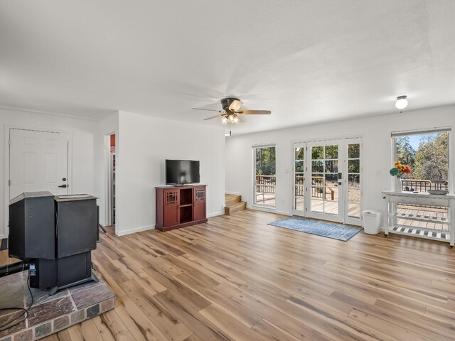 living room with ceiling fan, light hardwood / wood-style flooring, and a healthy amount of sunlight