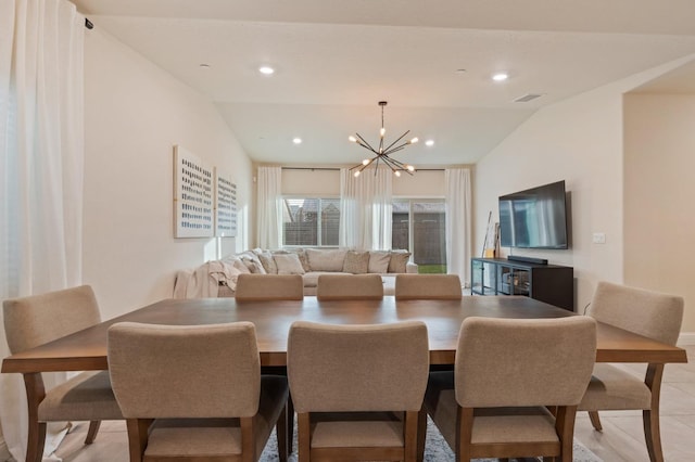 tiled dining room featuring an inviting chandelier