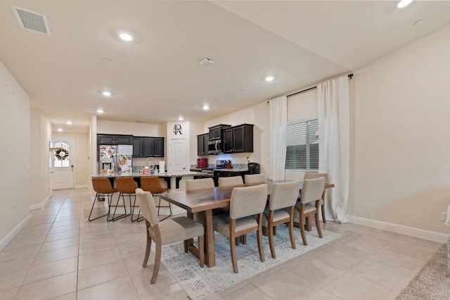 tiled dining room featuring sink