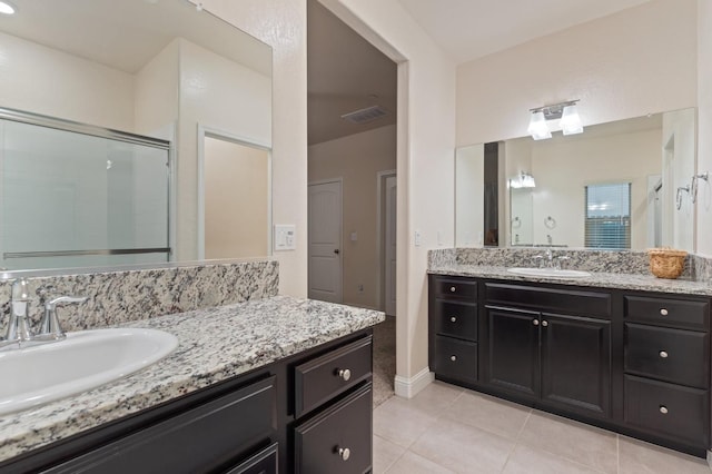 bathroom with tile patterned flooring, vanity, and an enclosed shower