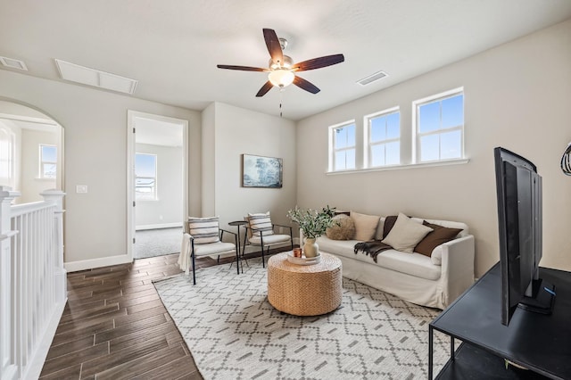 living room featuring a wealth of natural light and ceiling fan