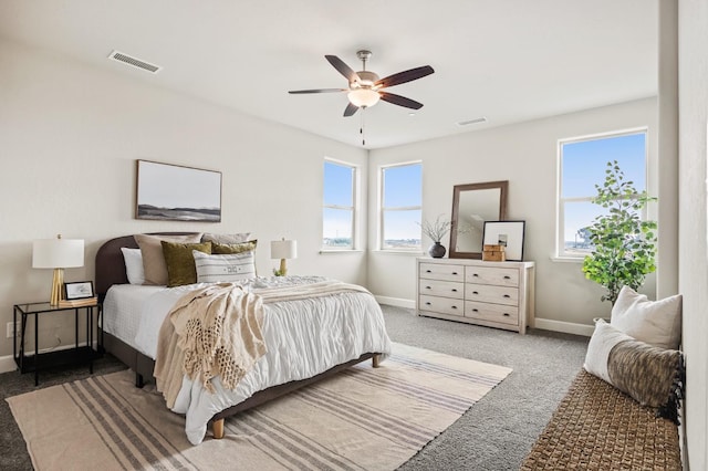 bedroom with ceiling fan and dark carpet