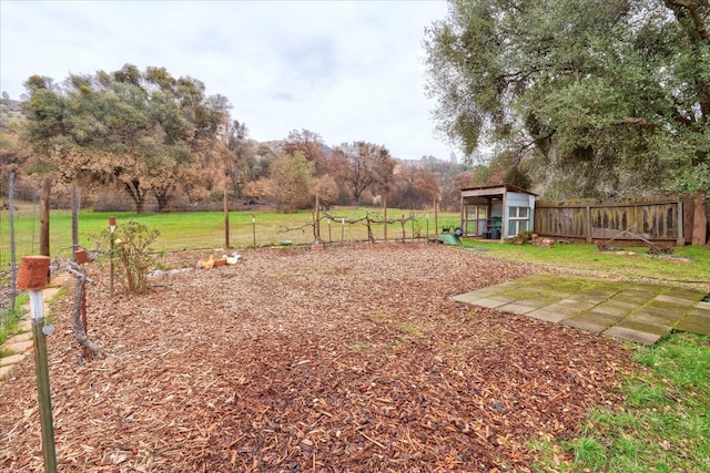 view of yard featuring an outbuilding and a rural view