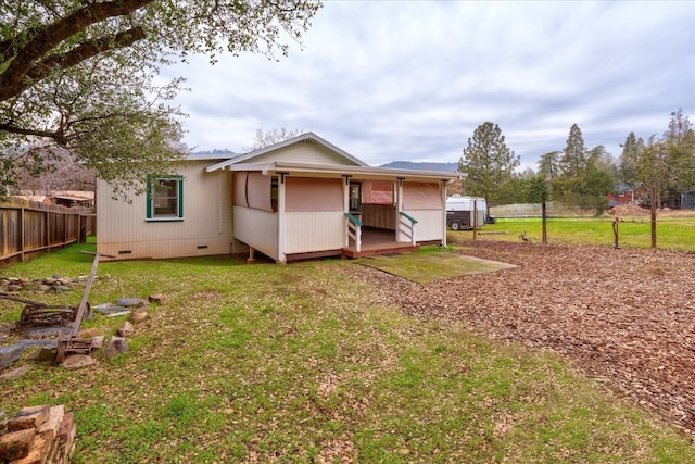 rear view of property featuring a yard