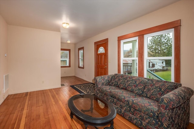 living room featuring wood-type flooring and cooling unit