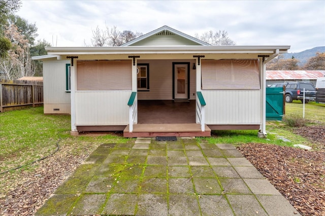 back of house with a lawn