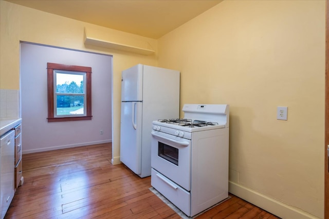 kitchen featuring white appliances and light hardwood / wood-style floors