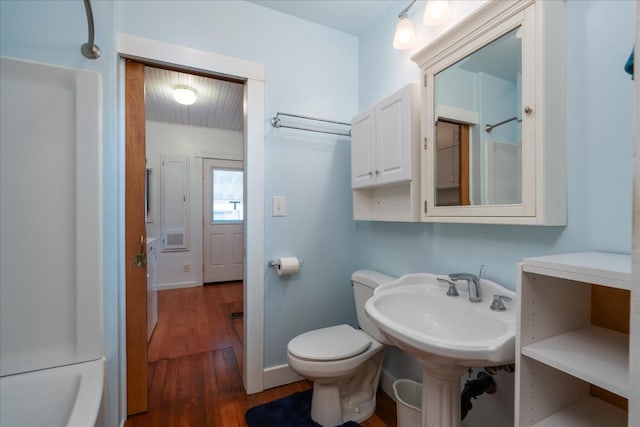 bathroom featuring hardwood / wood-style flooring, toilet, and independent shower and bath