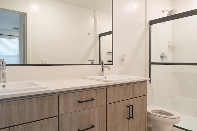 bathroom featuring vanity, toilet, and walk in shower