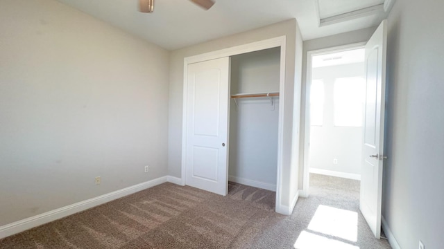 unfurnished bedroom with light colored carpet, ceiling fan, and a closet