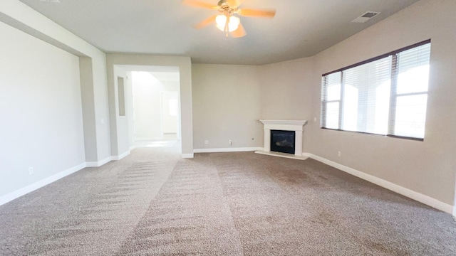 unfurnished living room with carpet flooring and ceiling fan