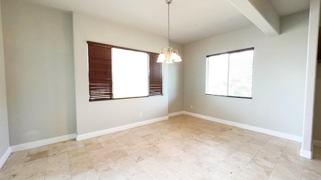 empty room with beamed ceiling and a chandelier