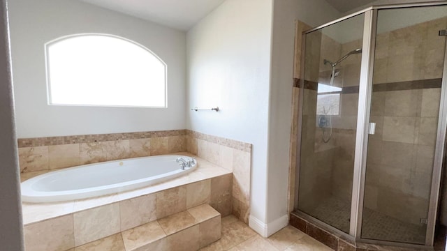 bathroom with independent shower and bath and tile patterned floors