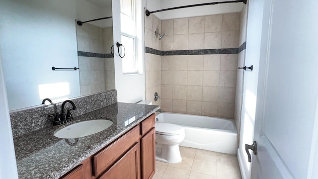 full bathroom with tiled shower / bath combo, vanity, tile patterned flooring, and toilet